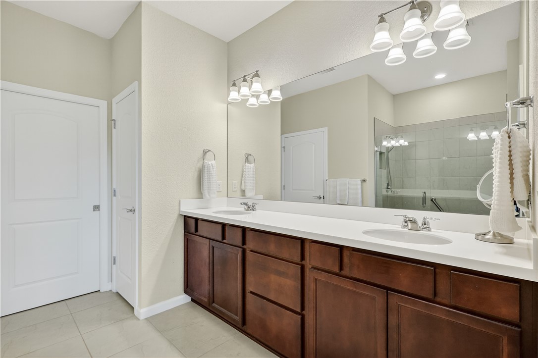 5130 Unity Square Vero Beach, FL 32967 - Photo 16 of 36 a bathroom with a double vanity sink and a mirror