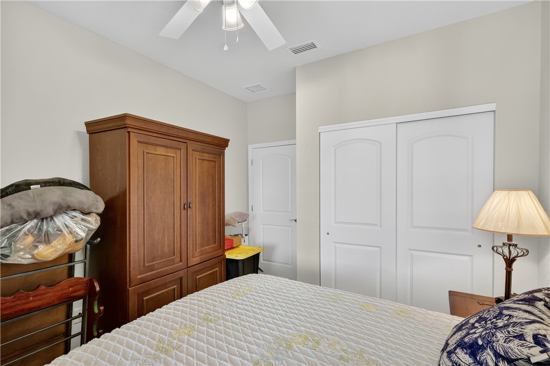5130 Unity Square Vero Beach, FL 32967 - Photo 19 of 36 a bedroom with a bed and a closet