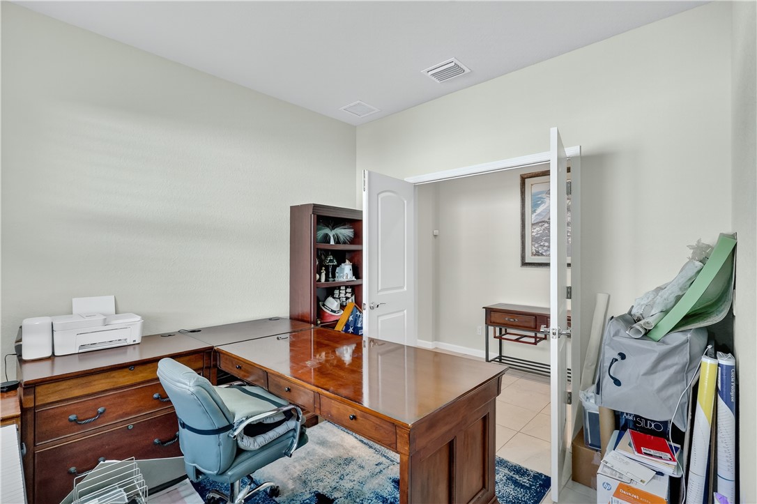5130 Unity Square Vero Beach, FL 32967 - Photo 22 of 36 a living room with furniture and a book shelf