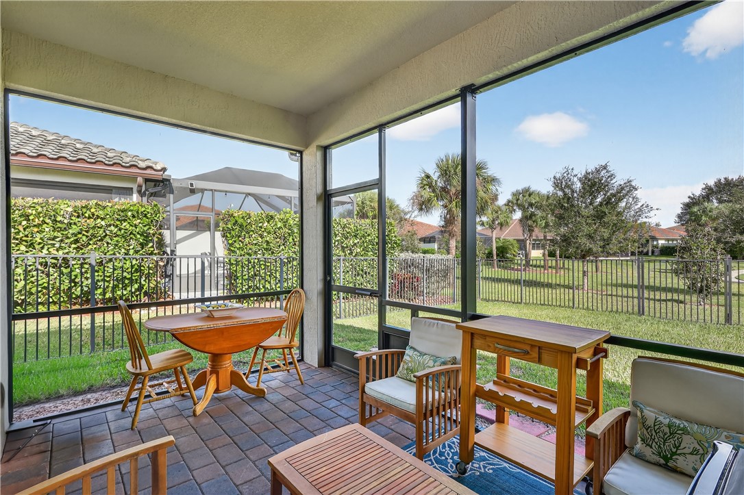 5130 Unity Square Vero Beach, FL 32967 - Photo 25 of 36 a living room with furniture and a floor to ceiling window