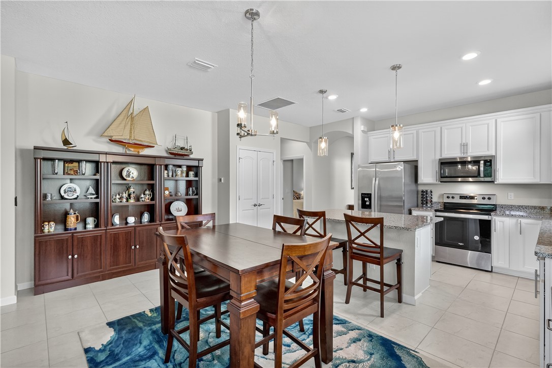 5130 Unity Square Vero Beach, FL 32967 - Photo 9 of 36 a view of a dining room with furniture