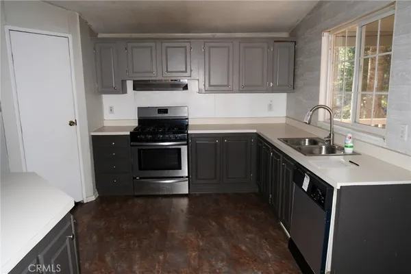 a kitchen with a sink stove and cabinets