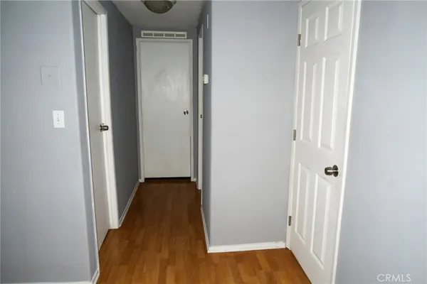 a view of a hallway with wooden floor