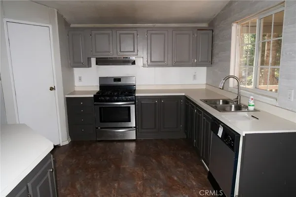 a kitchen with a sink stove and cabinets