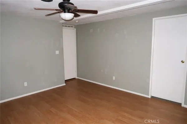 a view of an empty room with a ceiling fan