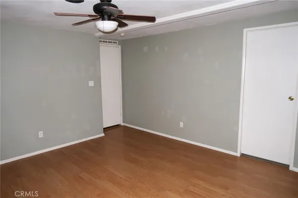 a view of an empty room with a ceiling fan