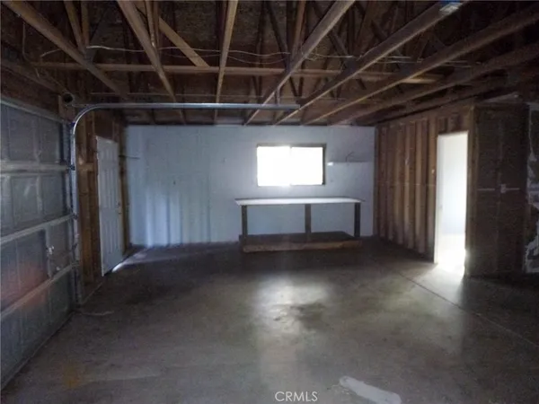 a view of empty room with wooden floor and windows