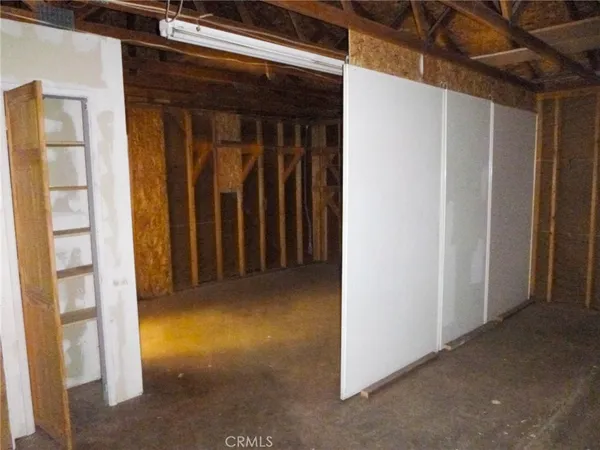 a view of a hallway with wooden shelves