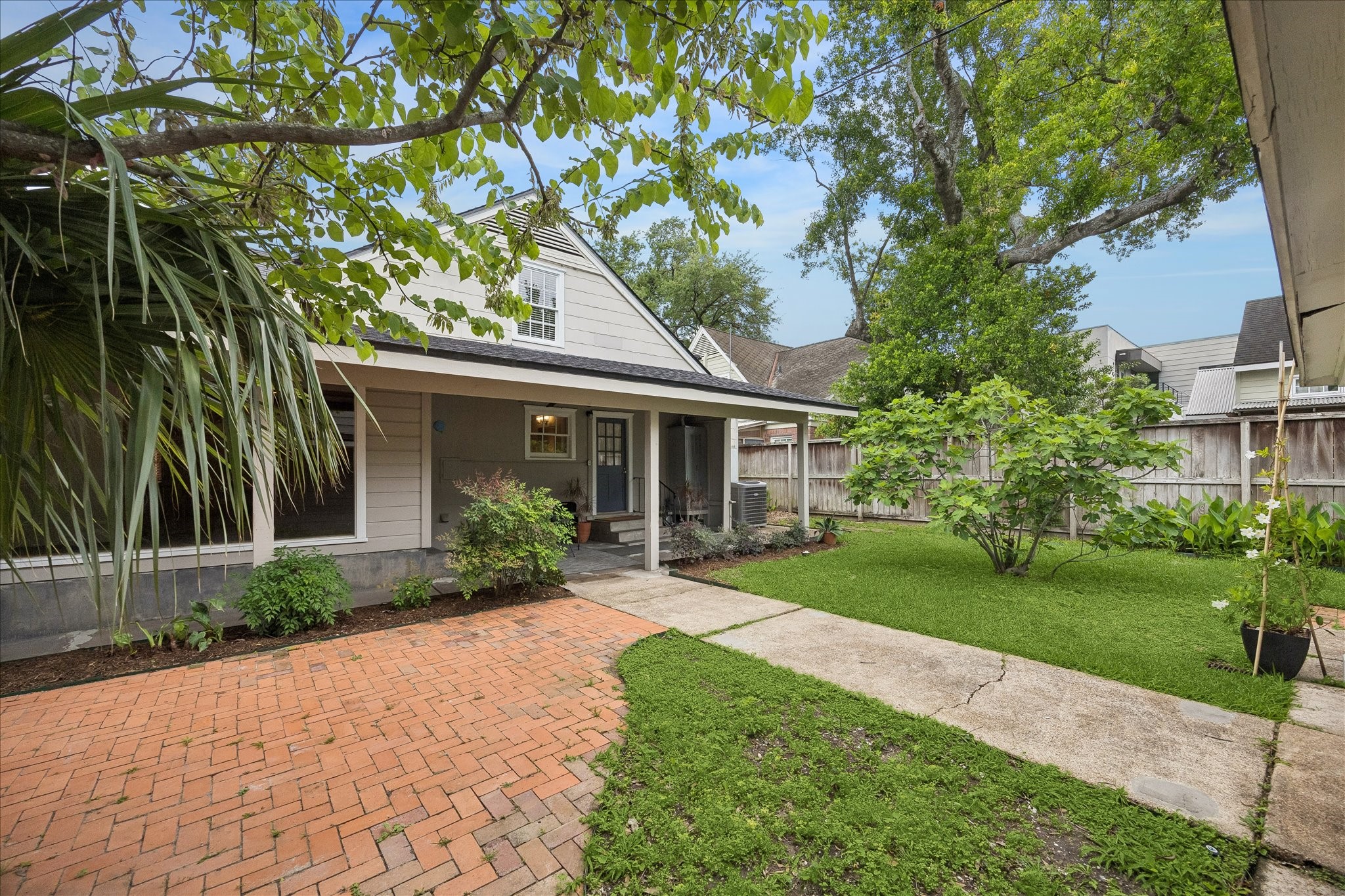2202 Colquitt Street Houston, TX 77098 - Photo 14 of 19 a front view of a house with a yard and potted plants