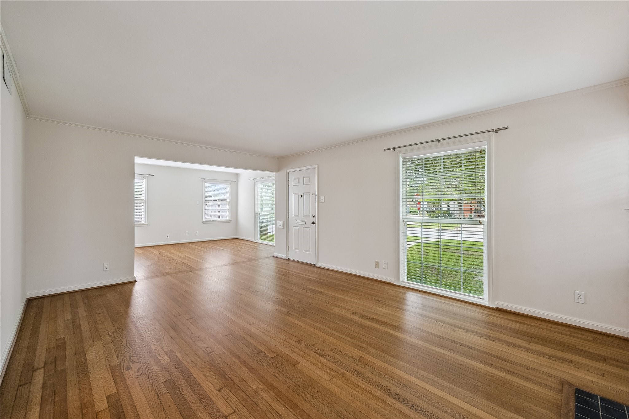 2202 Colquitt Street Houston, TX 77098 - Photo 2 of 19 a view of empty room with wooden floor and fan
