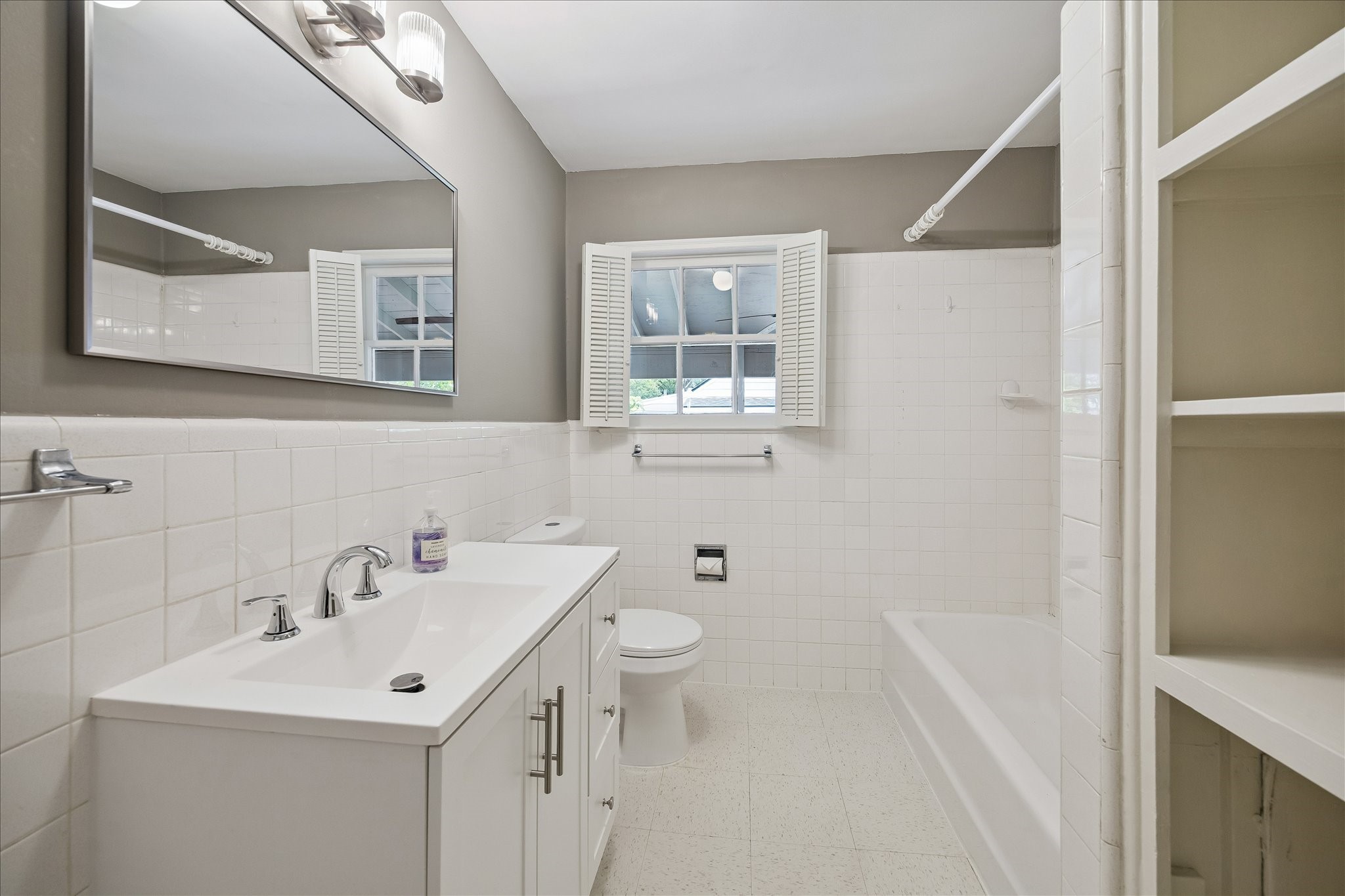 2202 Colquitt Street Houston, TX 77098 - Photo 9 of 19 a bathroom with a sink and mirror with toilet
