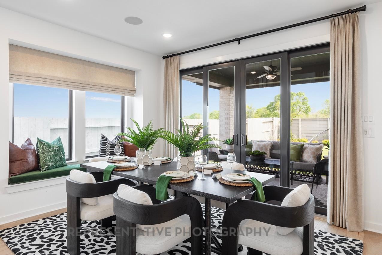 5327 Mango Blfs Street Manvel, TX 77578 - Photo 22 of 46 a dining room with furniture a large window and a rug