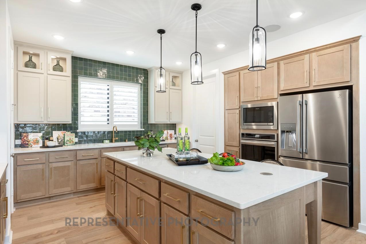 5327 Mango Blfs Street Manvel, TX 77578 - Photo 6 of 46 a kitchen with a sink a counter space appliances and cabinets