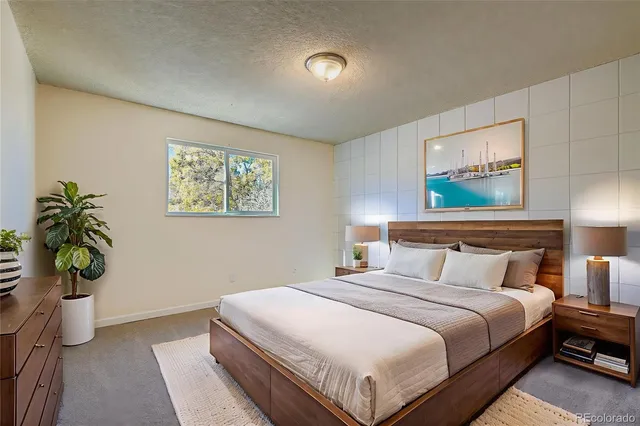 a bedroom with a bed and a potted plant