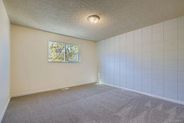 a bedroom with a large bed and a couch