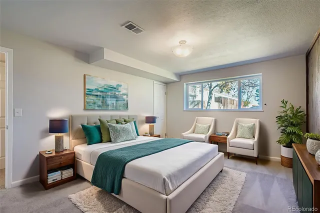 a bedroom with bed and a potted plant