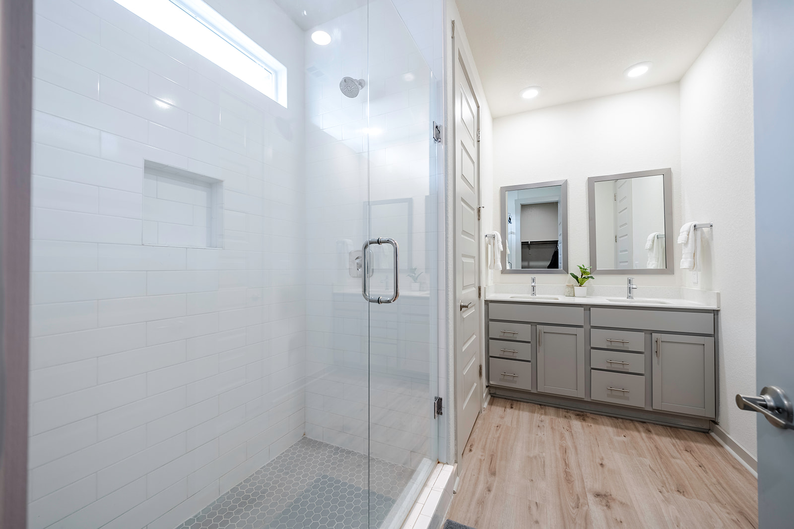 900 Balsora Cove Georgetown, TX 78628 - Photo 15 of 39 A well-lit primary bathroom features a frameless glass shower and dual vanity.