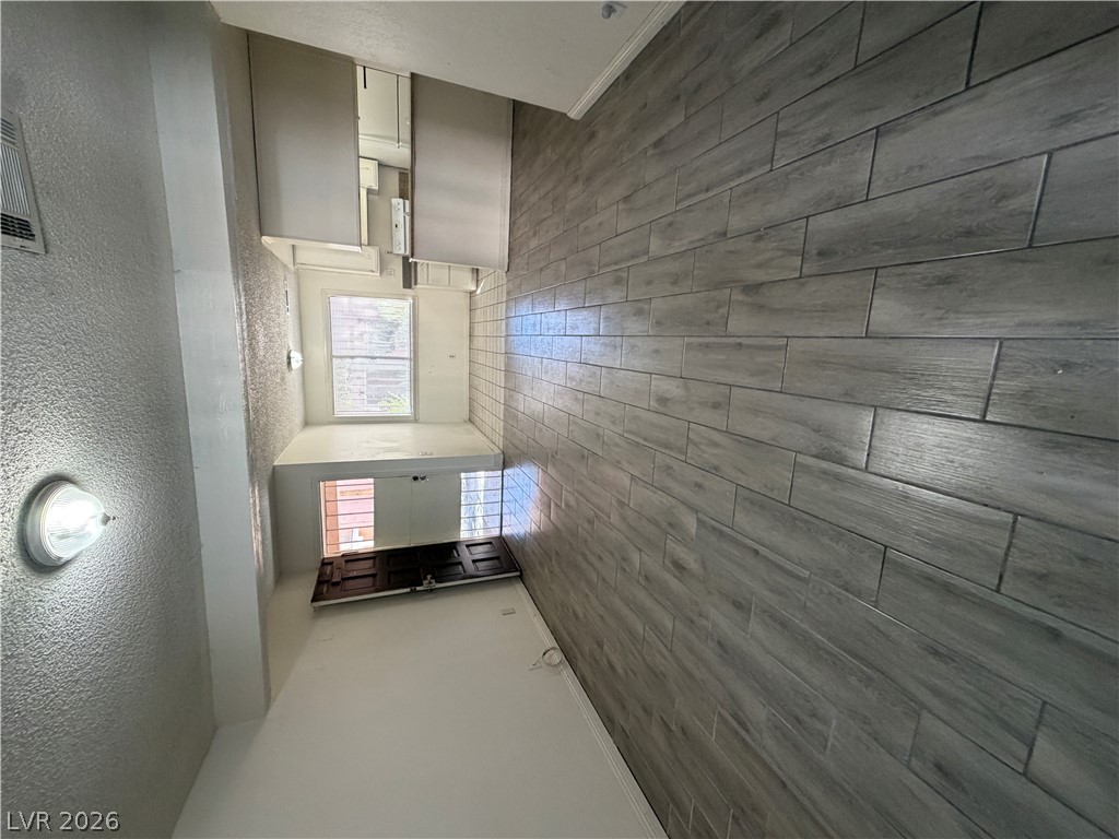 2236 East Desert Inn Road Las Vegas, NV 89169 - Photo 5 of 34 Clean lines and a striking accent wall create a modern, inviting ambiance.
