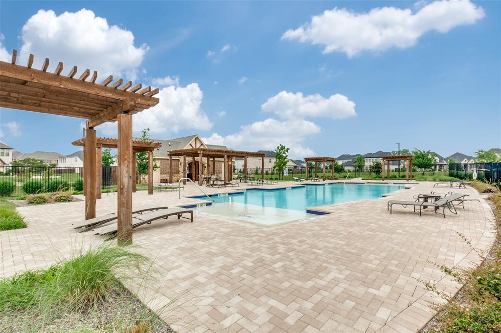 1888 Strand Street Dallas, TX 75234 - Photo 13 of 13 Community swimming pool with an integrated tanning ledge, surrounded by a paver deck