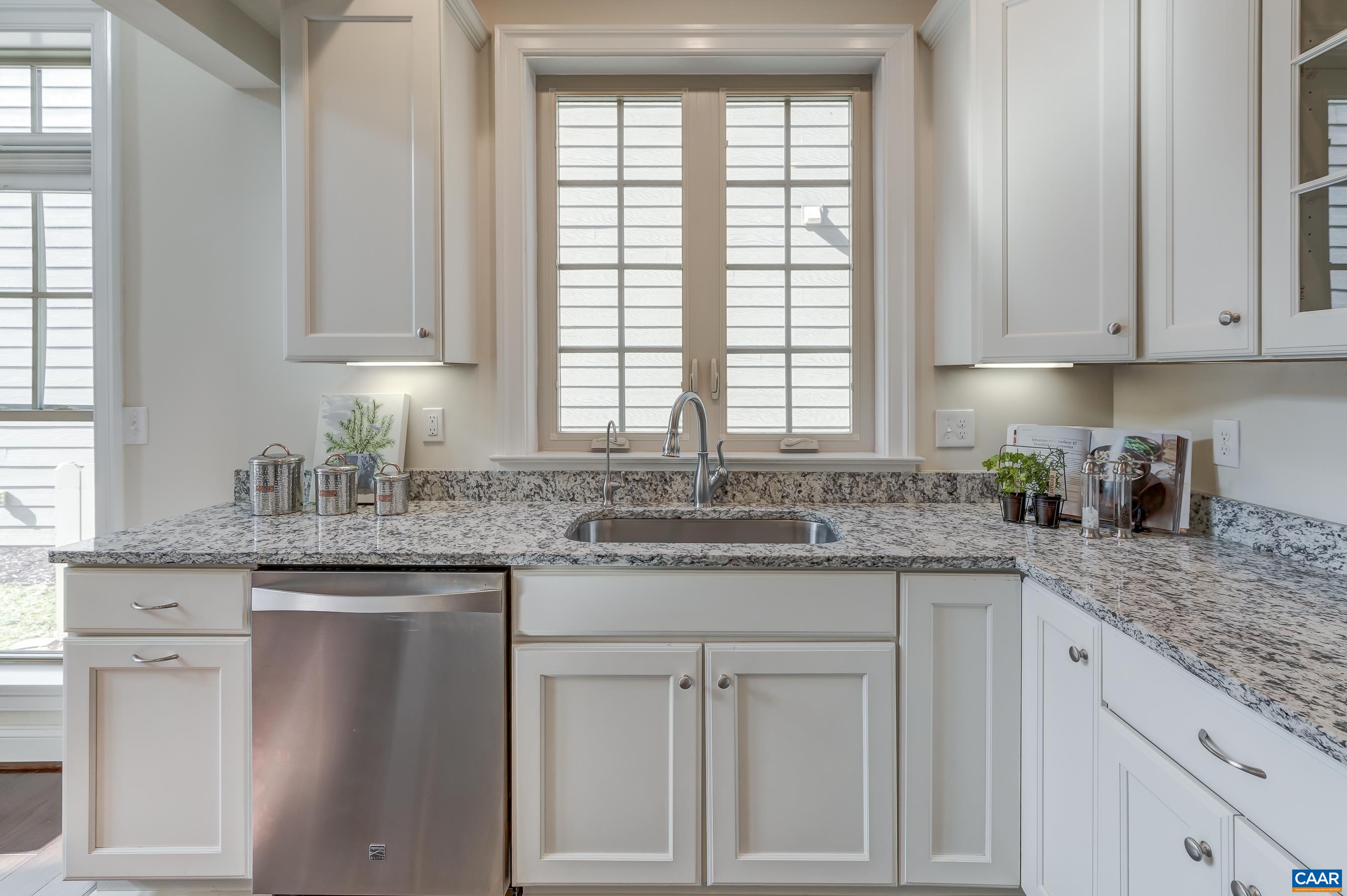 804 Golf View Drive Crozet, VA 22932 - Photo 12 of 62 a kitchen with granite countertop white cabinets and white stainless steel appliances