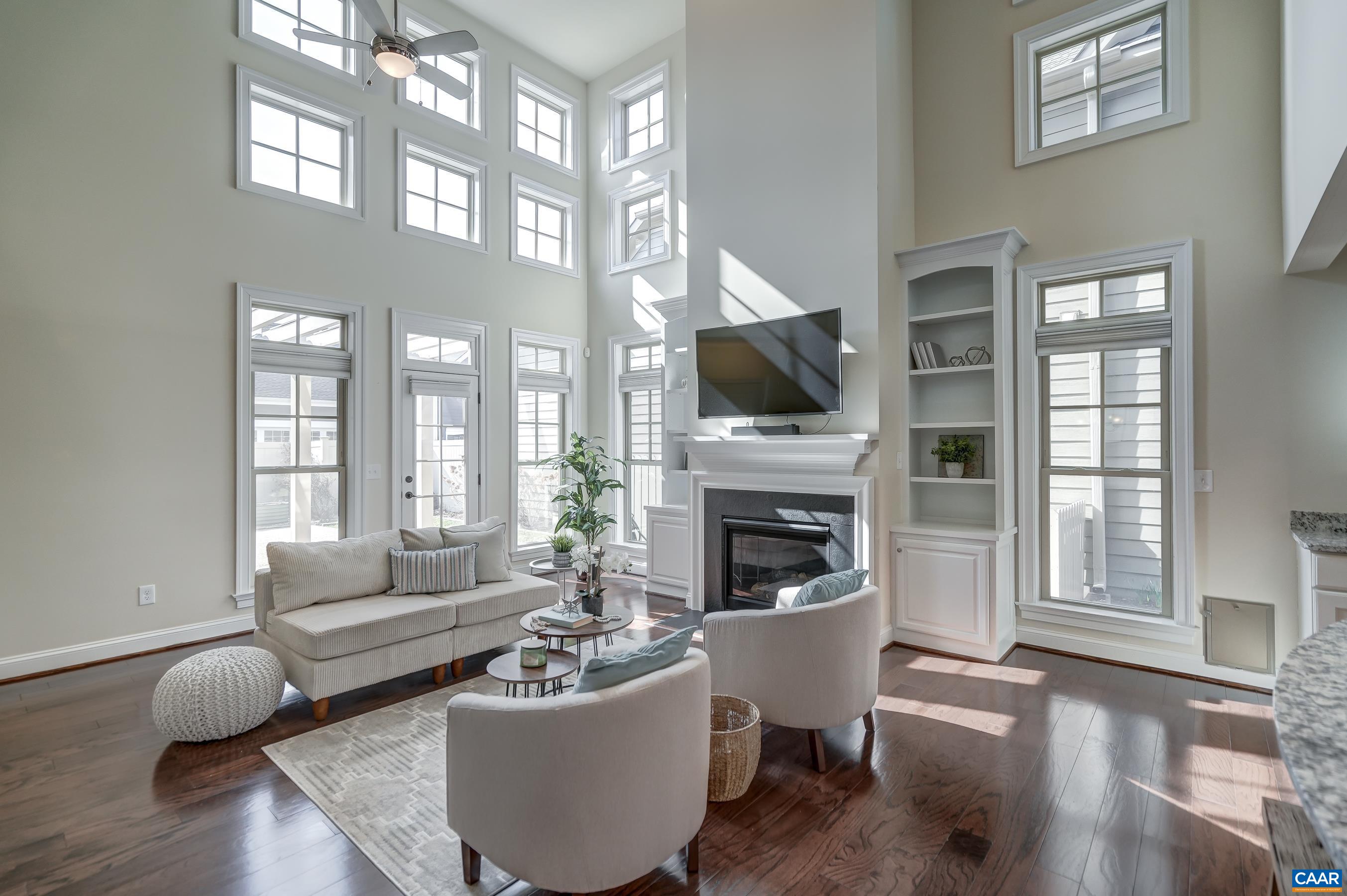 804 Golf View Drive Crozet, VA 22932 - Photo 15 of 62 a living room with furniture a fireplace and a flat screen tv