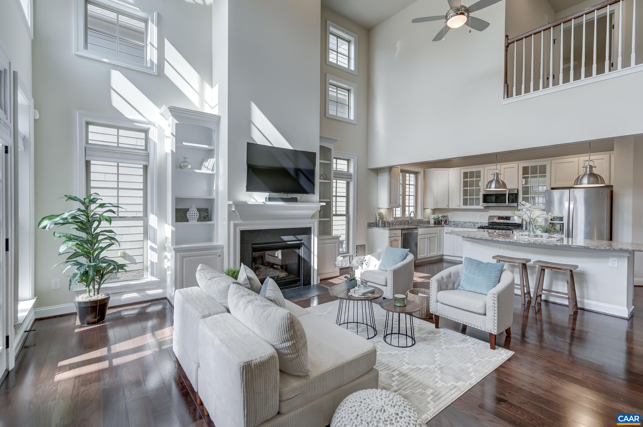 804 Golf View Drive Crozet, VA 22932 - Photo 16 of 62 a living room with furniture a fireplace and a potted plant