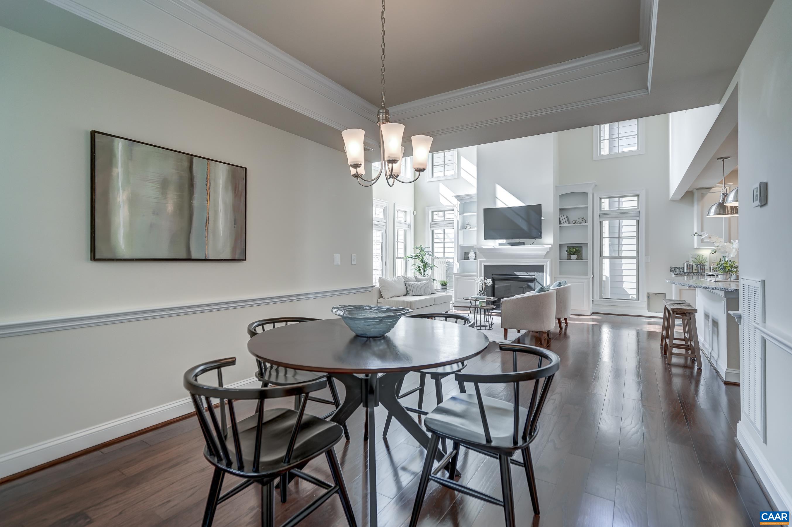 804 Golf View Drive Crozet, VA 22932 - Photo 21 of 62 a dining room with furniture wooden floor a chandelier and a painting