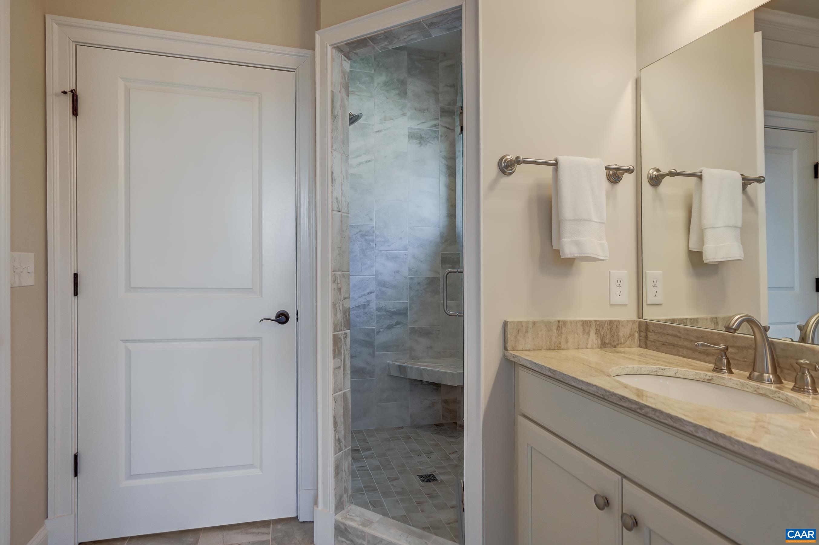 804 Golf View Drive Crozet, VA 22932 - Photo 30 of 62 a bathroom with a granite countertop sink a mirror and shower
