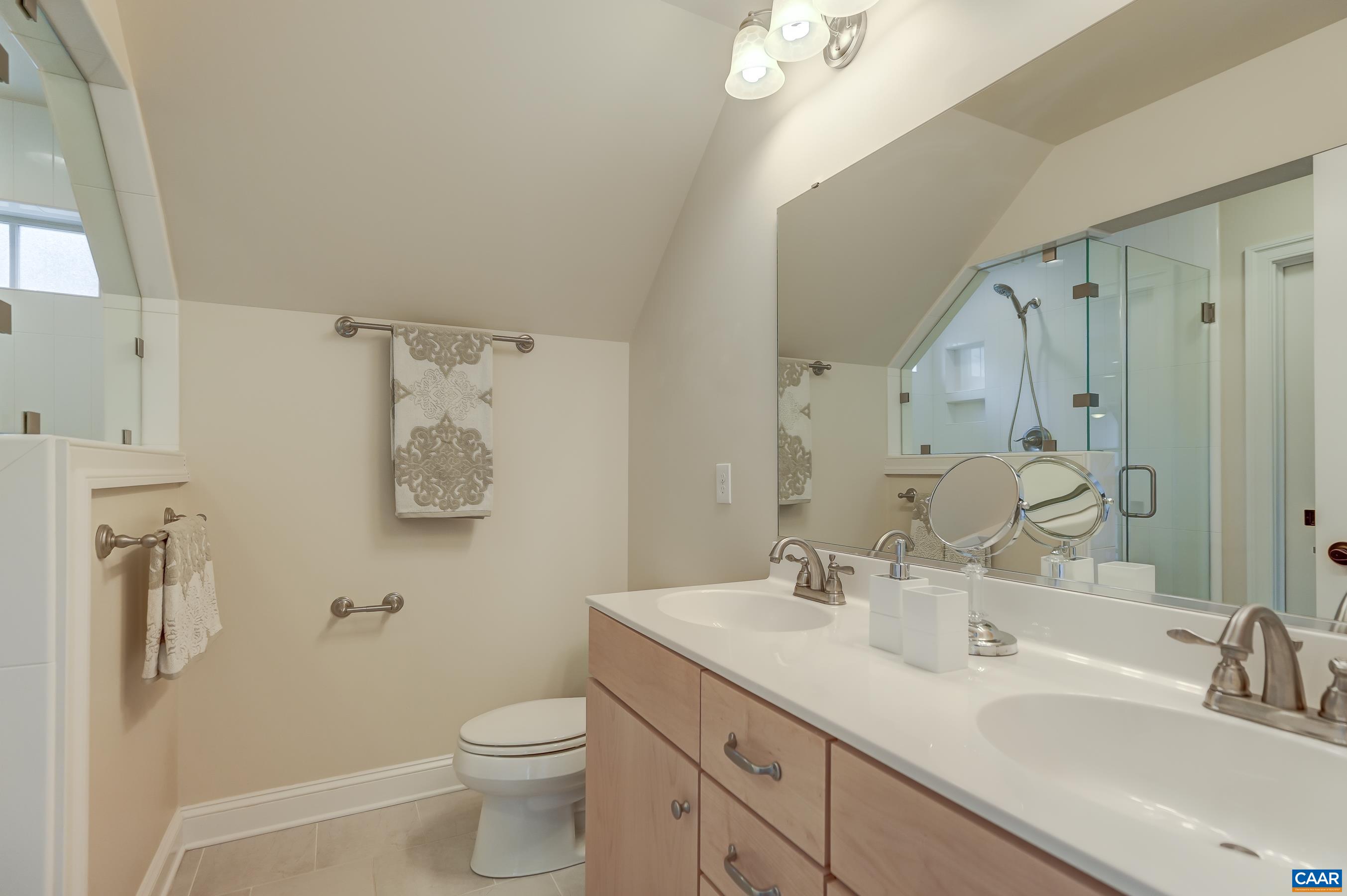 804 Golf View Drive Crozet, VA 22932 - Photo 36 of 62 a bathroom with a double vanity sink toilet and a mirror