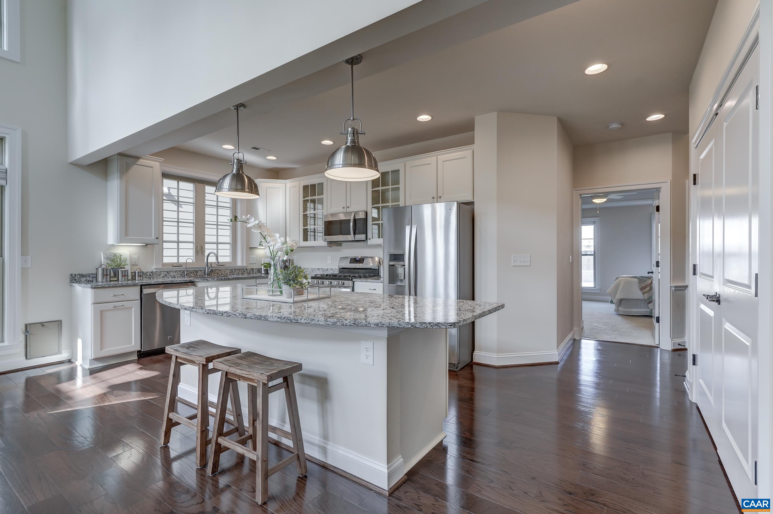 804 Golf View Drive Crozet, VA 22932 - Photo 7 of 62 a kitchen with stainless steel appliances kitchen island granite countertop a table chairs refrigerator and microwave