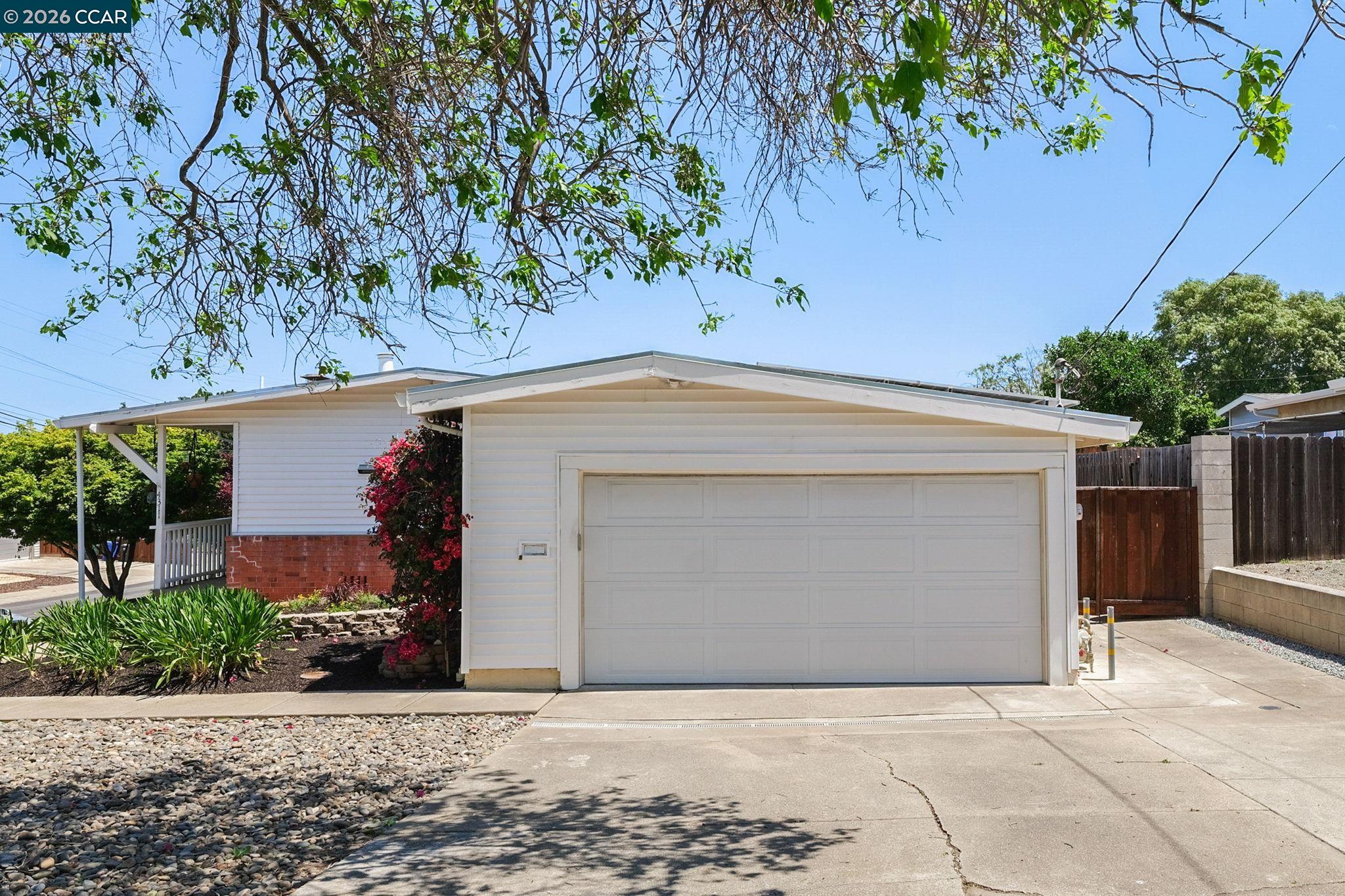 4311 Cowell Road Concord, CA 94521 - Photo 4 of 29 a front view of a house with a garage