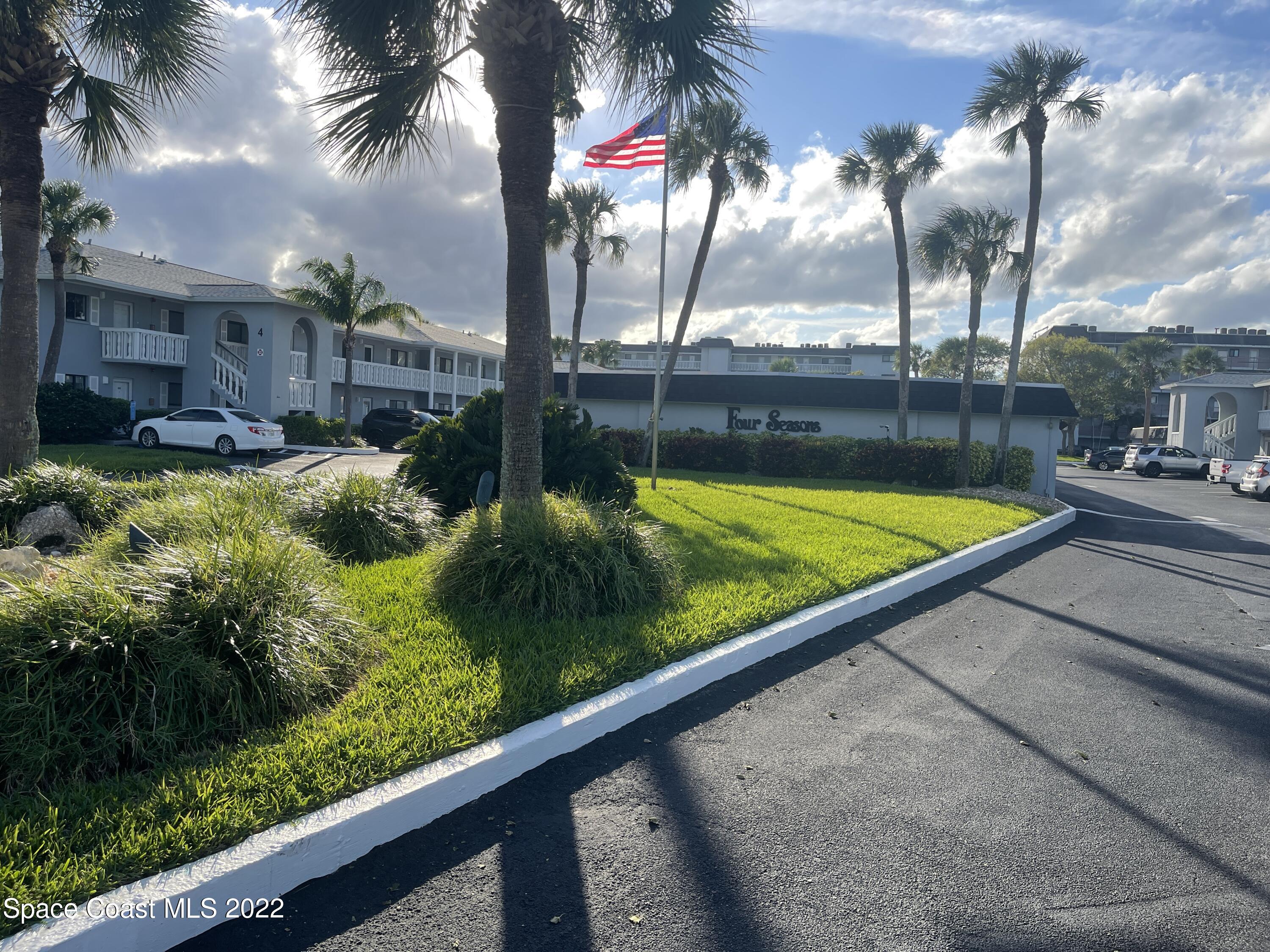 a view of swimming pool with a yard and potted plants