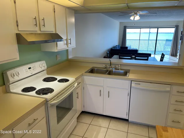 a kitchen with a sink a stove and cabinets