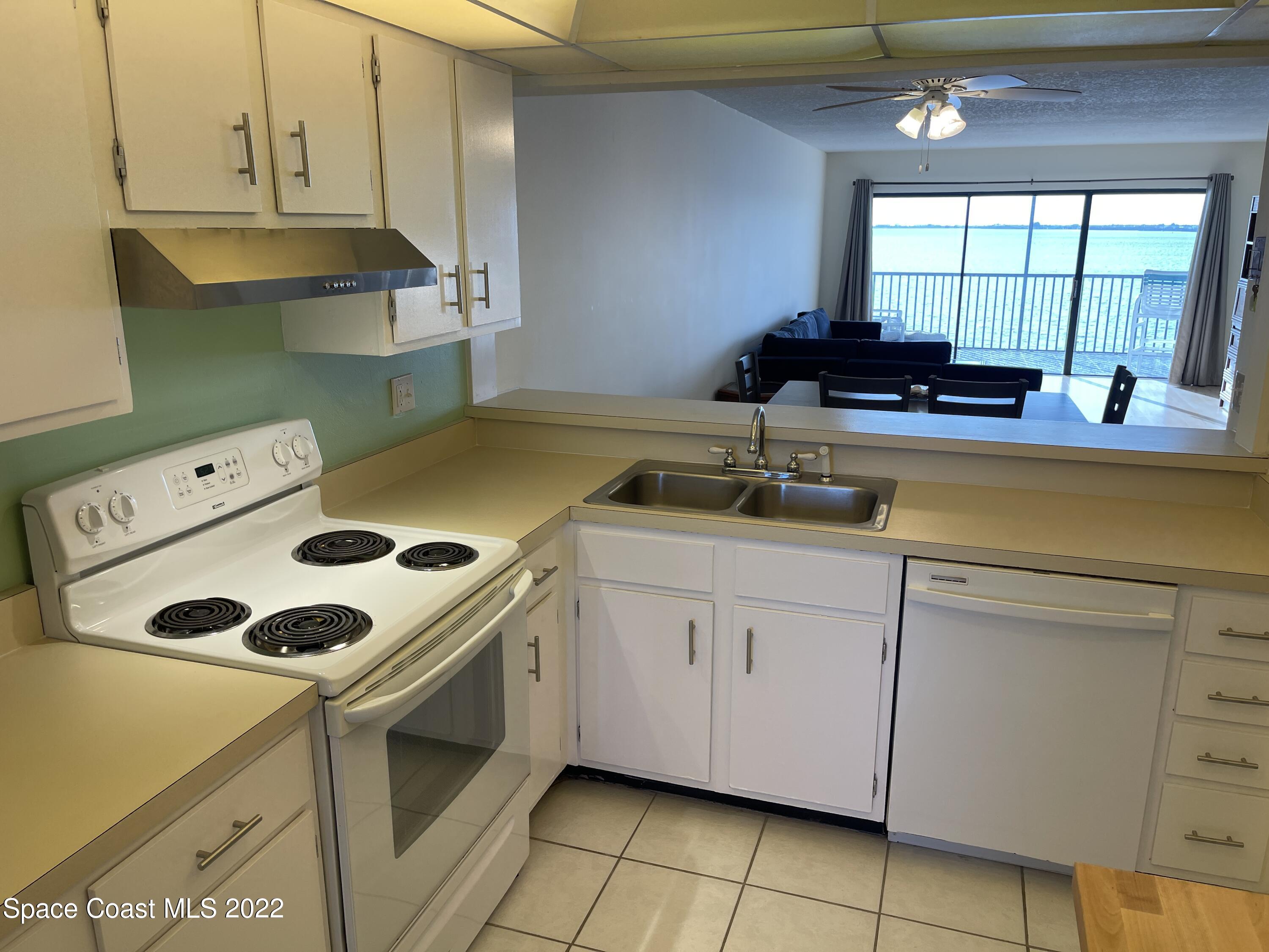 3799 South Banana River Boulevard, Unit 817 Cocoa Beach, FL 32931 - Photo 12 of 26 a kitchen with a sink a stove and cabinets