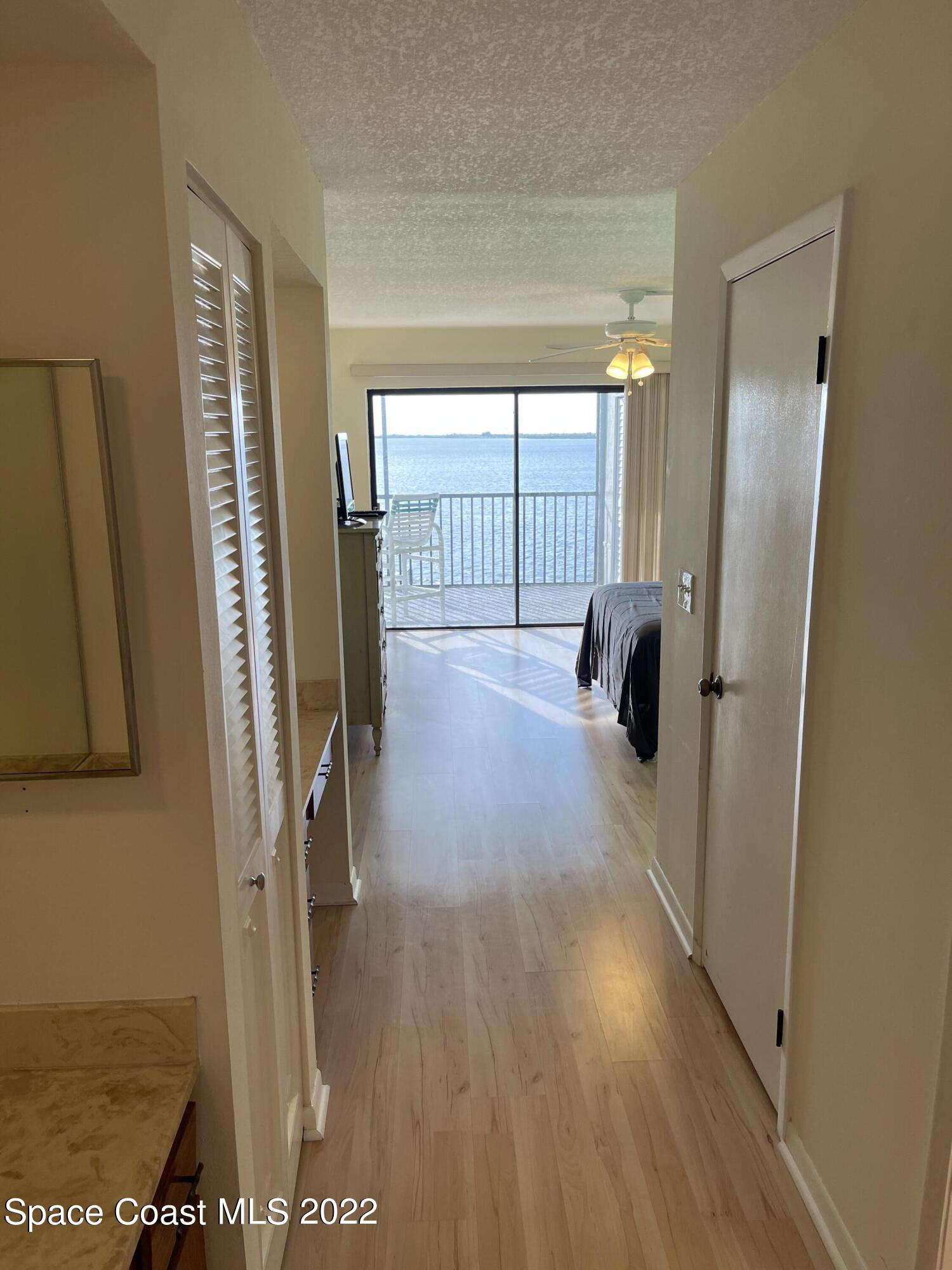 3799 South Banana River Boulevard, Unit 817 Cocoa Beach, FL 32931 - Photo 15 of 26 a view of hallway with stairs and wooden floor