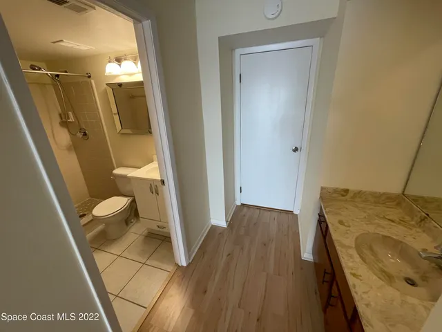 a bathroom with a sink and mirror with toilet