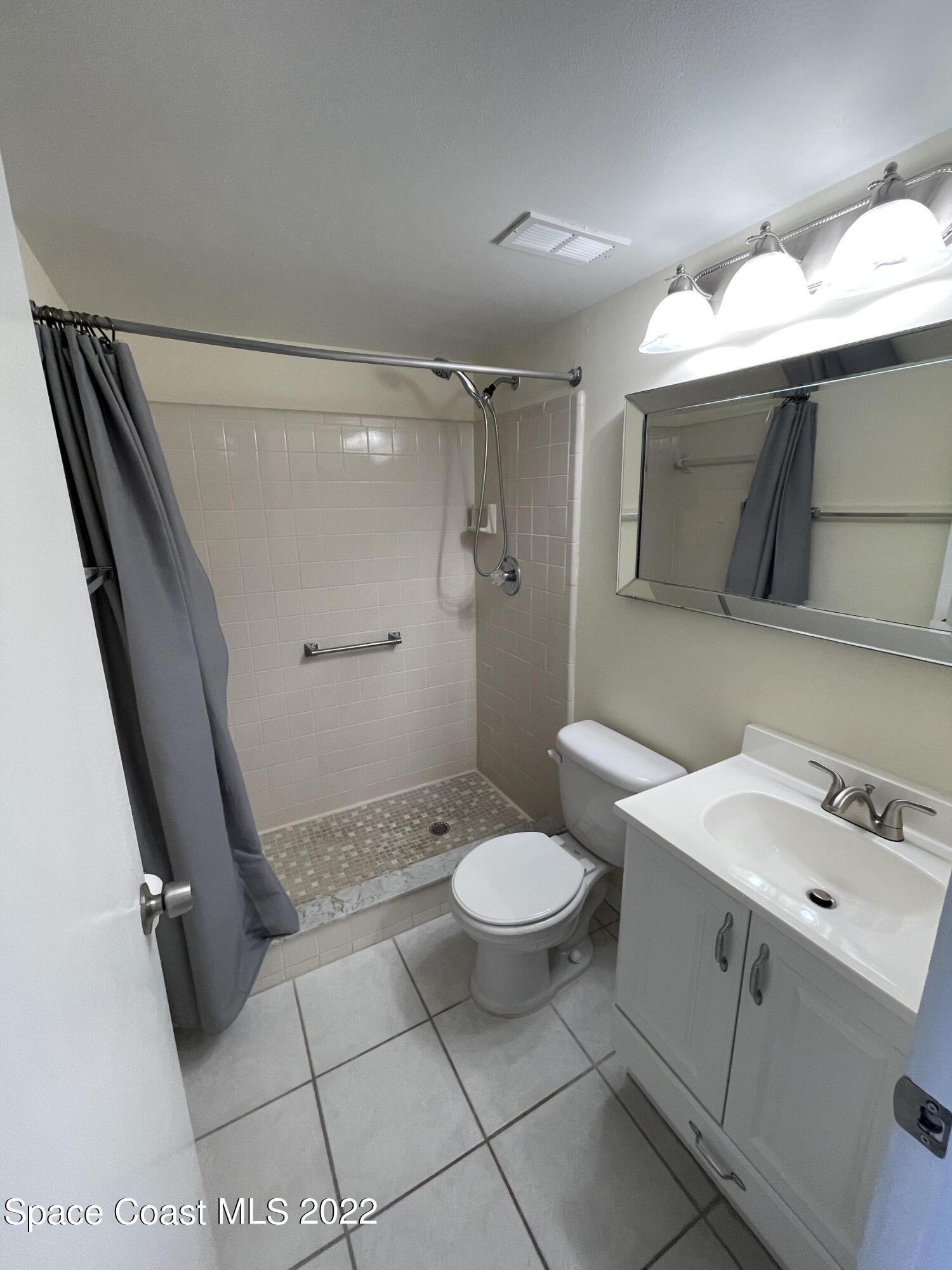 3799 South Banana River Boulevard, Unit 817 Cocoa Beach, FL 32931 - Photo 20 of 26 a bathroom with a sink toilet and shower