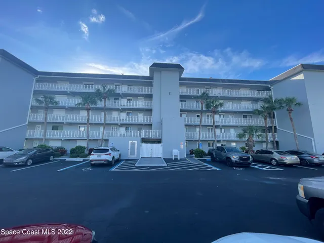 a living room with a couch and a bookshelf