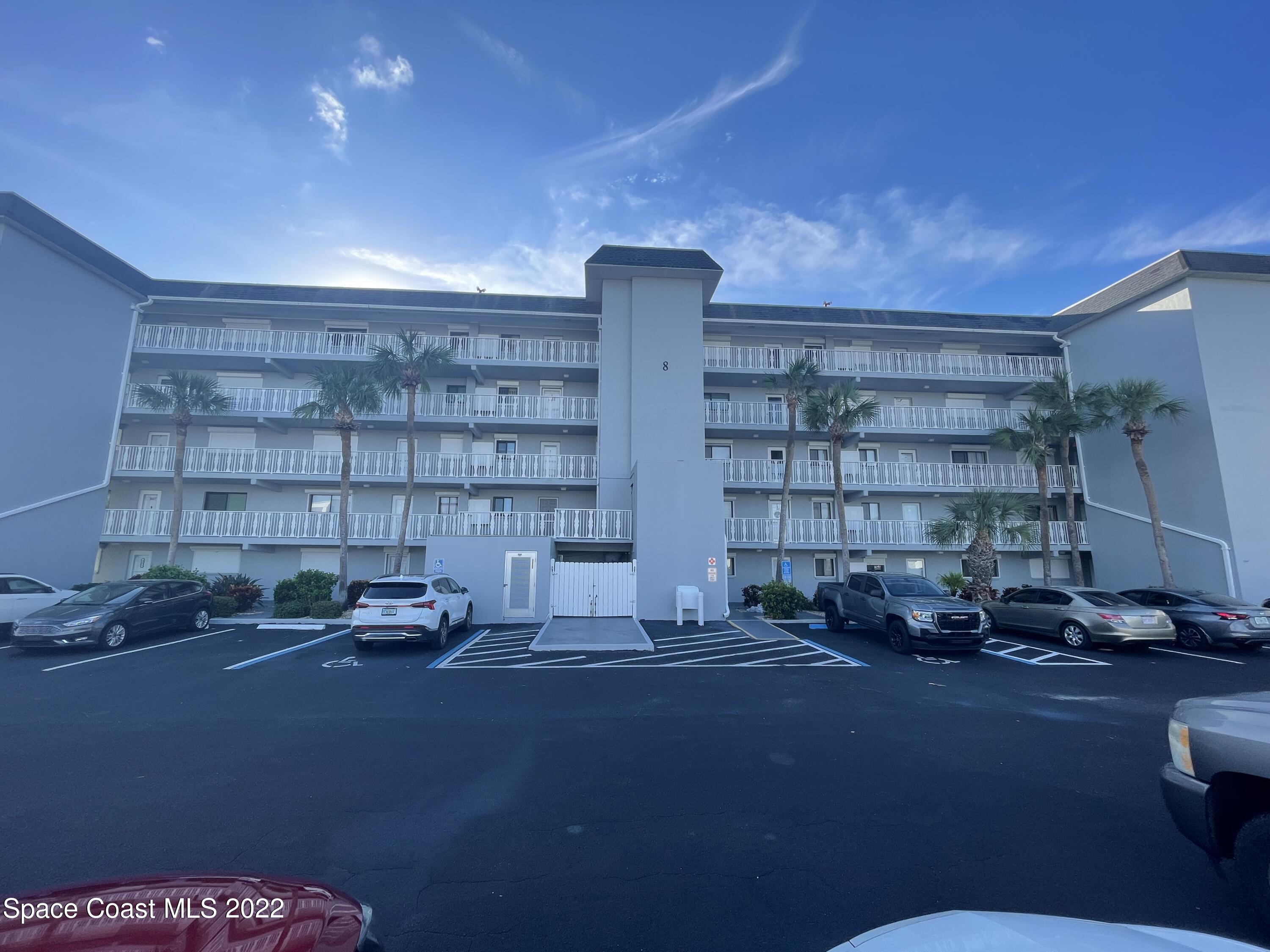 3799 South Banana River Boulevard, Unit 817 Cocoa Beach, FL 32931 - Photo 2 of 26 a living room with a couch and a bookshelf