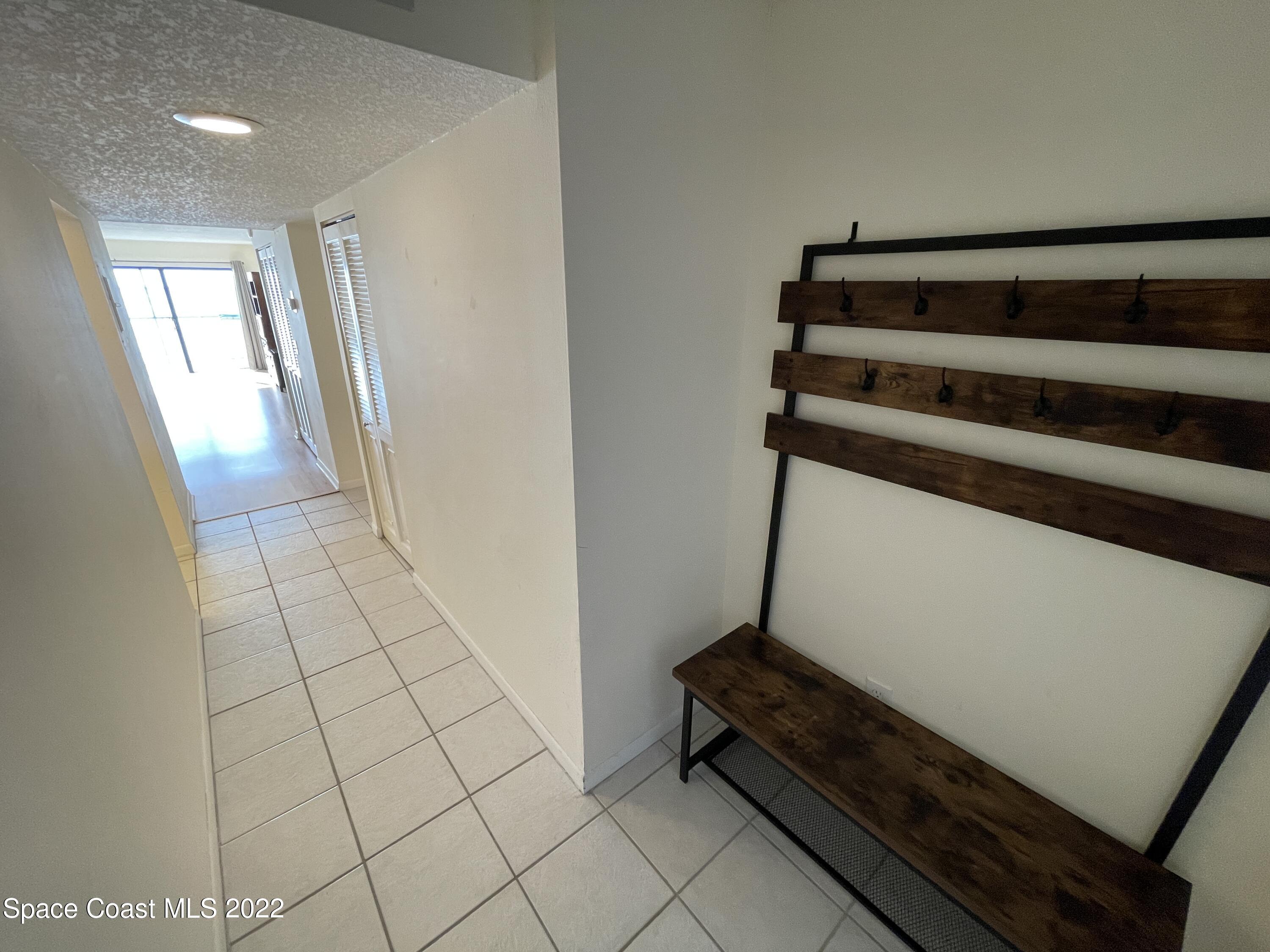 3799 South Banana River Boulevard, Unit 817 Cocoa Beach, FL 32931 - Photo 5 of 26 a view of an empty room and wooden floor