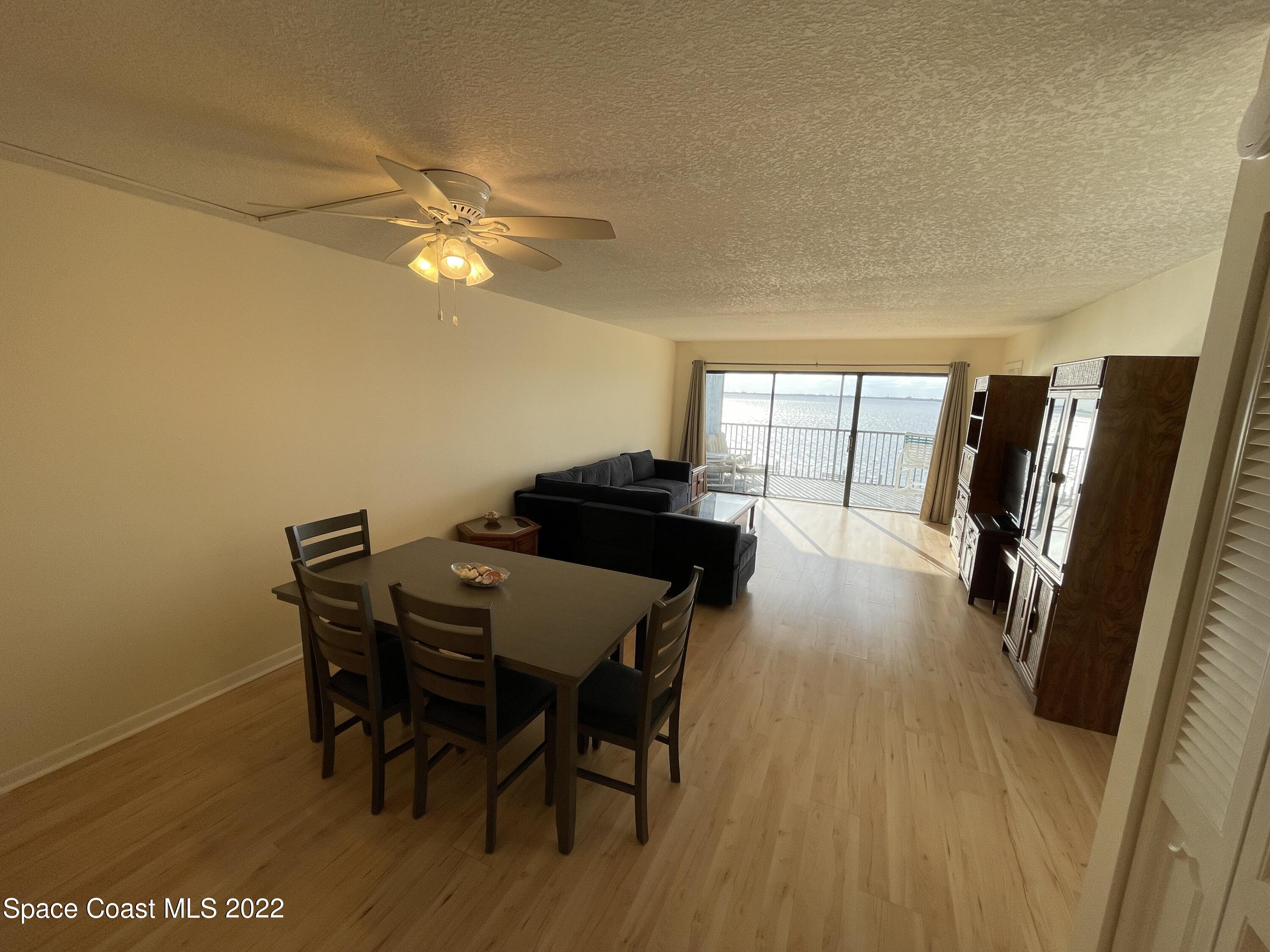 3799 South Banana River Boulevard, Unit 817 Cocoa Beach, FL 32931 - Photo 6 of 26 a view of a dining room with furniture and a chandelier