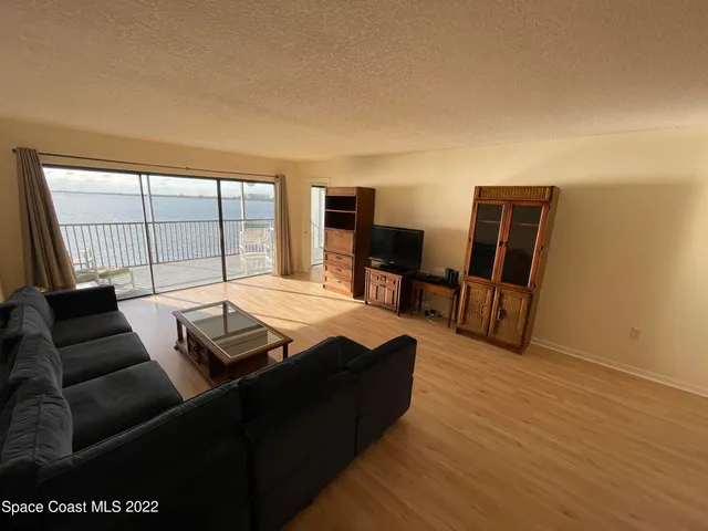 a living room with furniture fireplace and flat screen tv