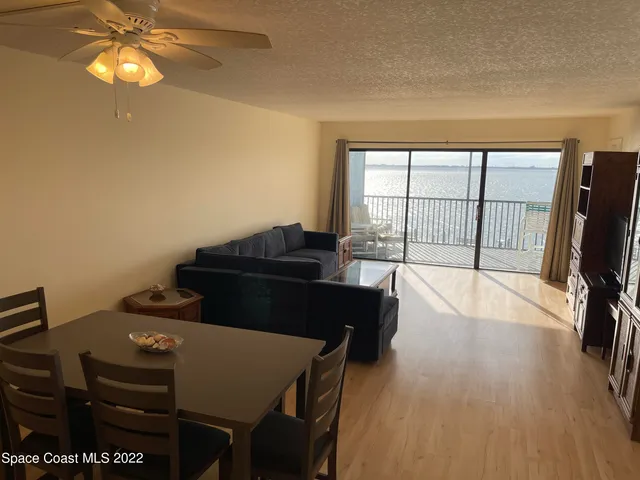 a view of a workspace with furniture and a flat screen tv