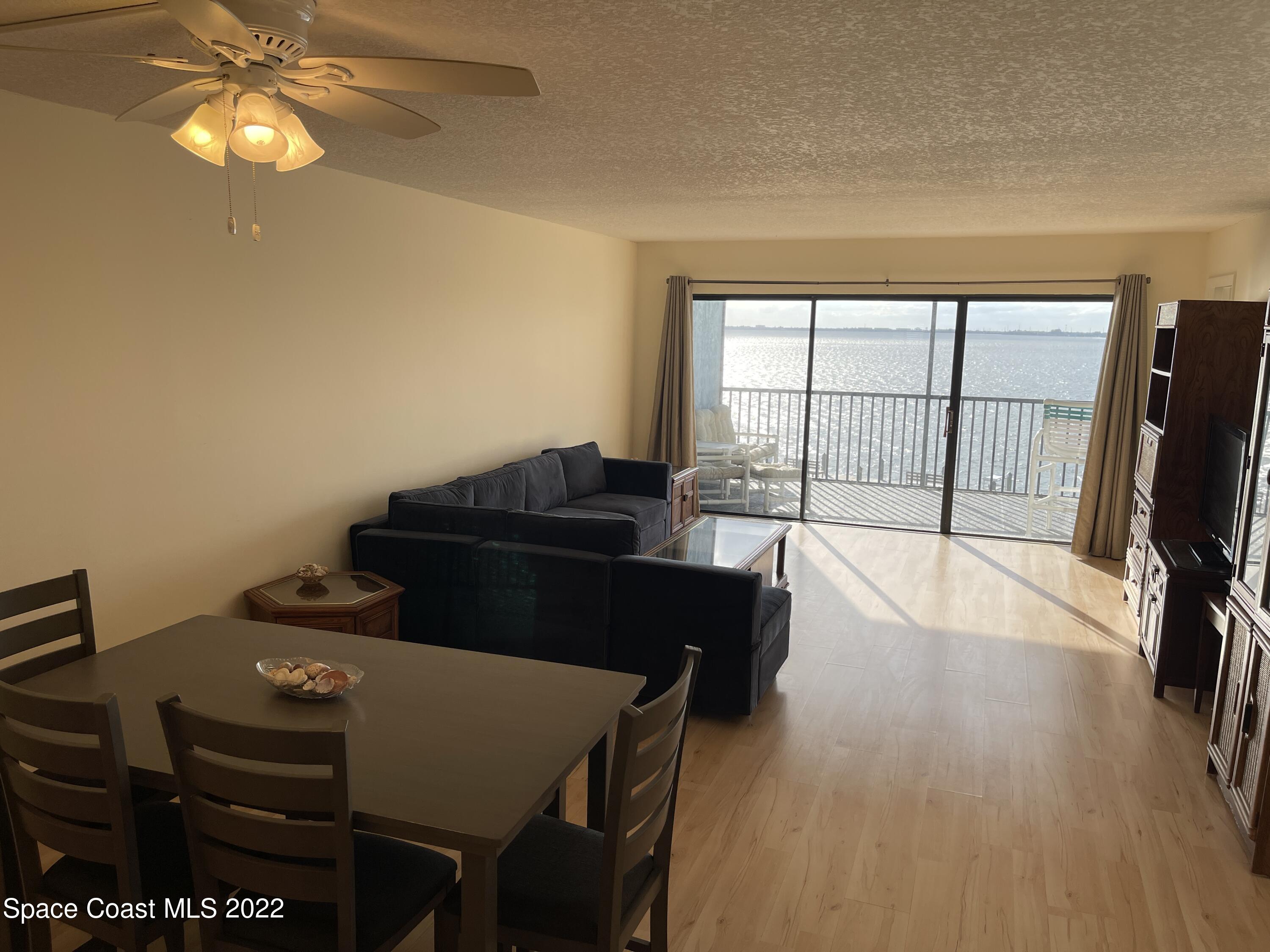 3799 South Banana River Boulevard, Unit 817 Cocoa Beach, FL 32931 - Photo 8 of 26 a view of a workspace with furniture and a flat screen tv