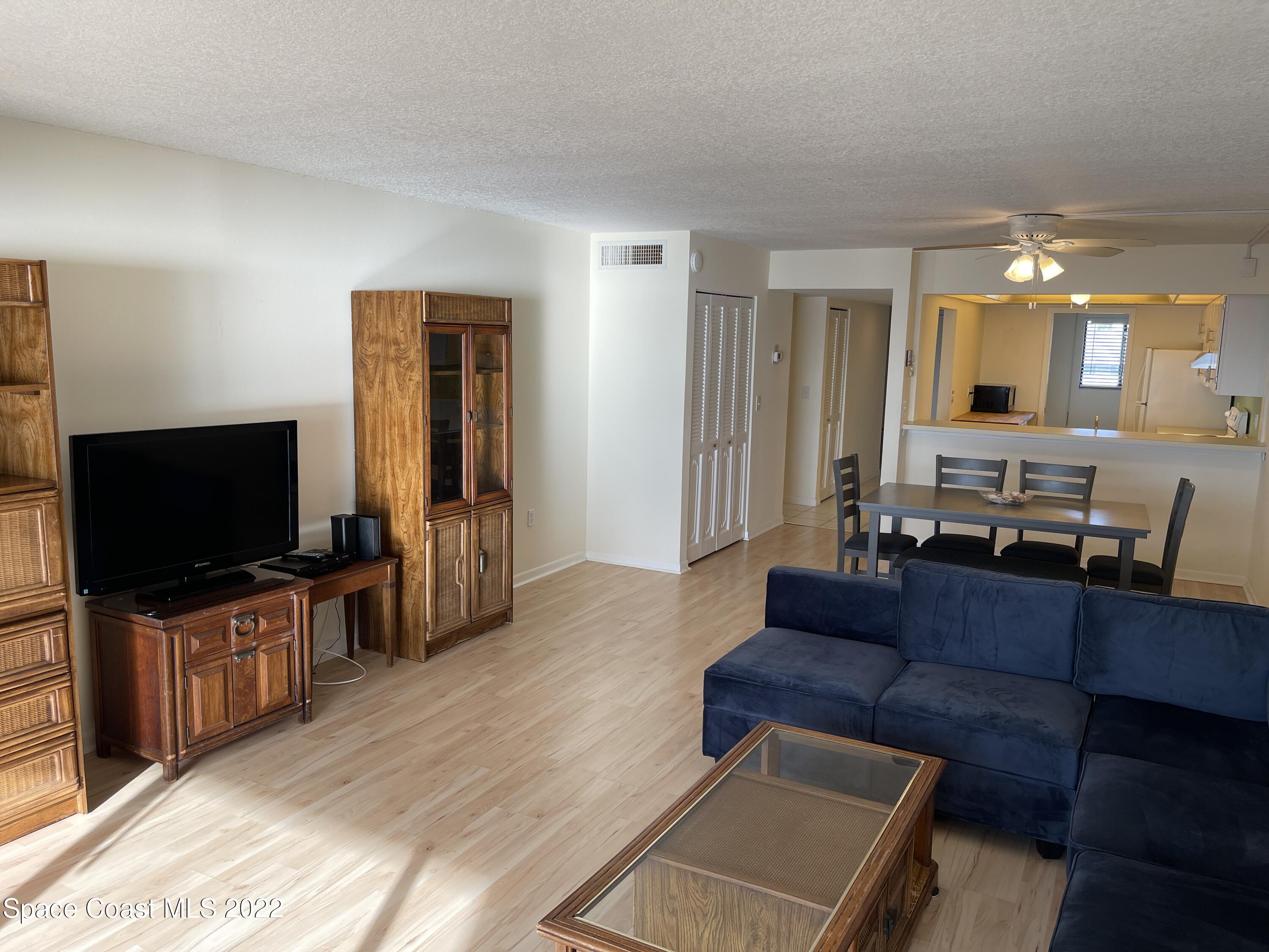 3799 South Banana River Boulevard, Unit 817 Cocoa Beach, FL 32931 - Photo 10 of 26 a living room with furniture and a flat screen tv