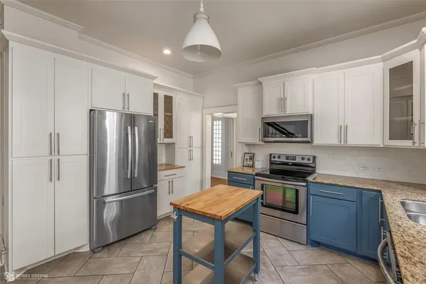 a kitchen with a refrigerator a sink and cabinets