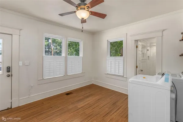 a kitchen with a wooden floor and a stove top oven