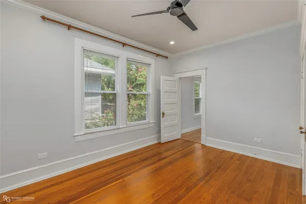 an empty room with wooden floor and closet