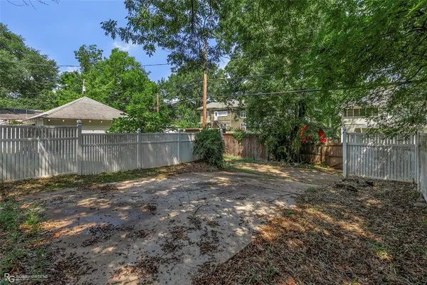 a view of a backyard with large trees