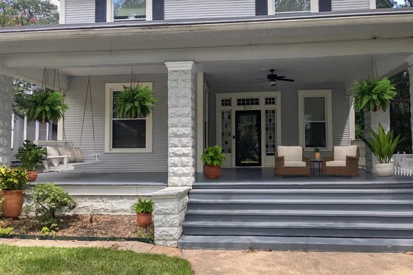 a front view of a house with a garden